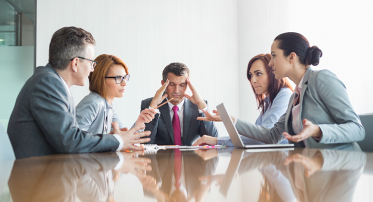 Professionals in a conference room arguing