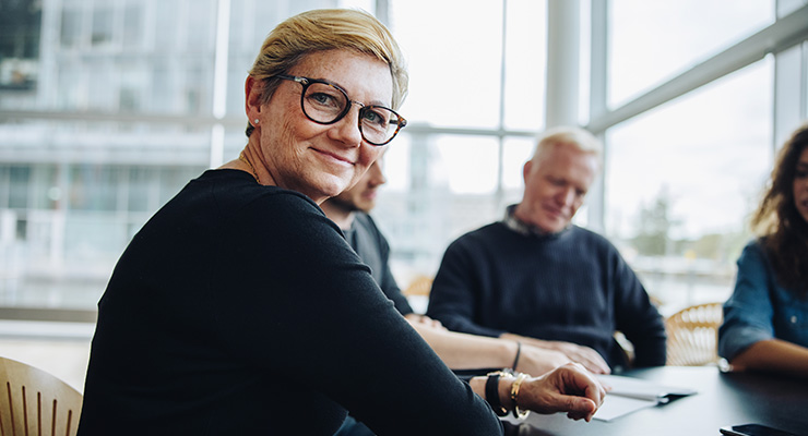 Board member around conference table, smiling