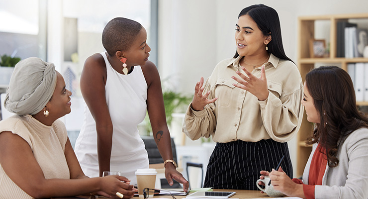 Young businesswoman talking expressively to her colleagues