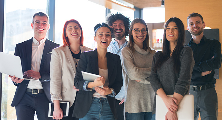 Group of young business leaders laughing together