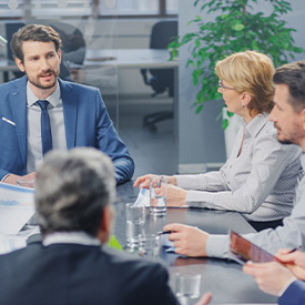 Business leaders conversing around table