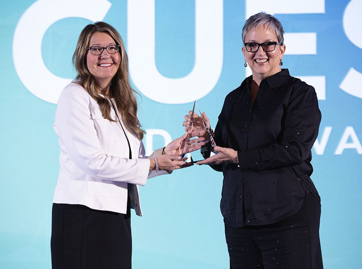 CUES CEO Heather McKissick, presents the 2024 CUES Distinguished Director award to Julia Cronin-Gilmore, Ph.D., Chairperson of the Board of Directors at Cobalt Credit Union, celebrating Dr. Cronin-Gilmore's exceptional leadership and unwavering dedication to governance in the credit union movement