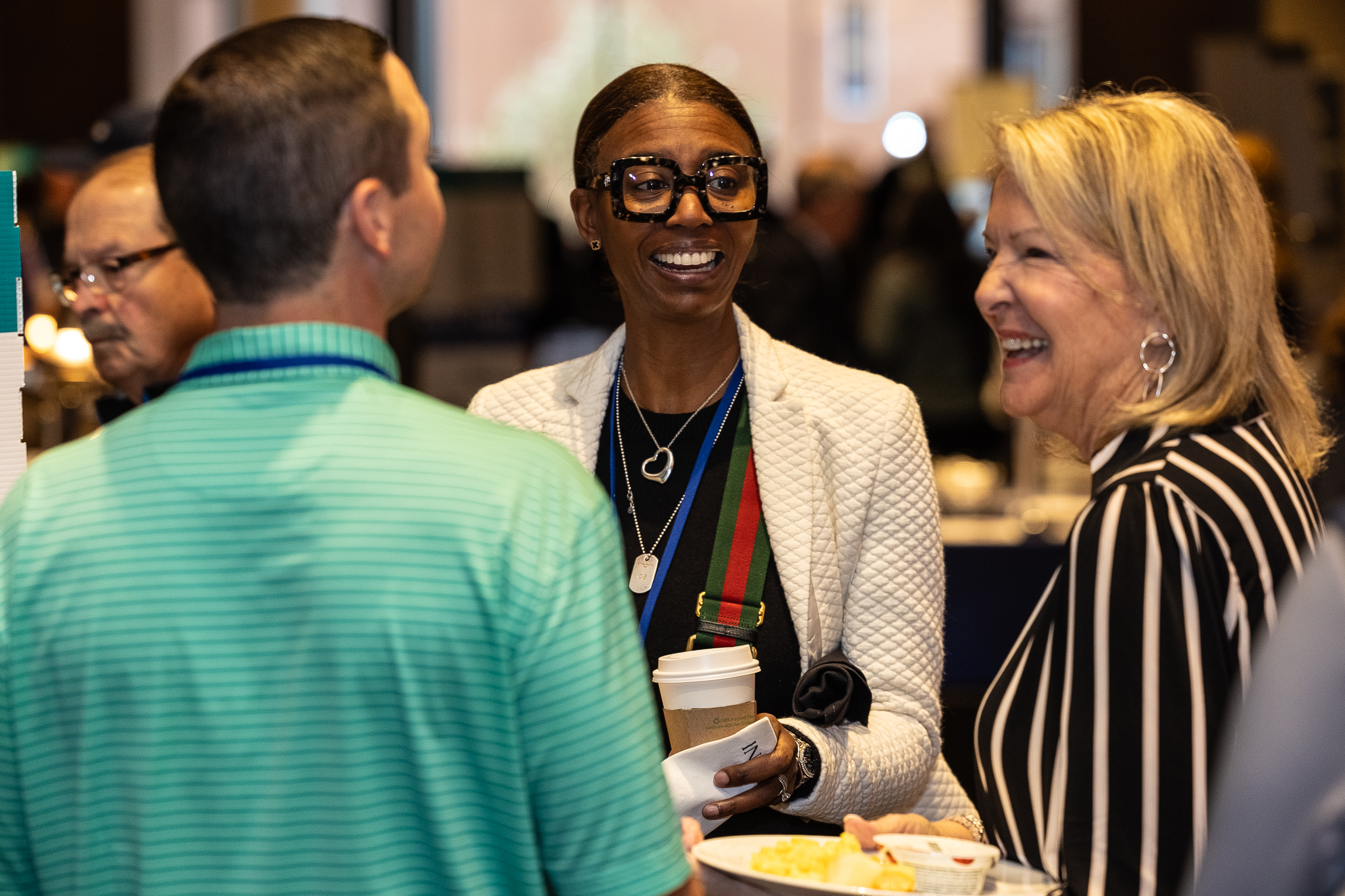 Attendees enjoying conversation in ballroom