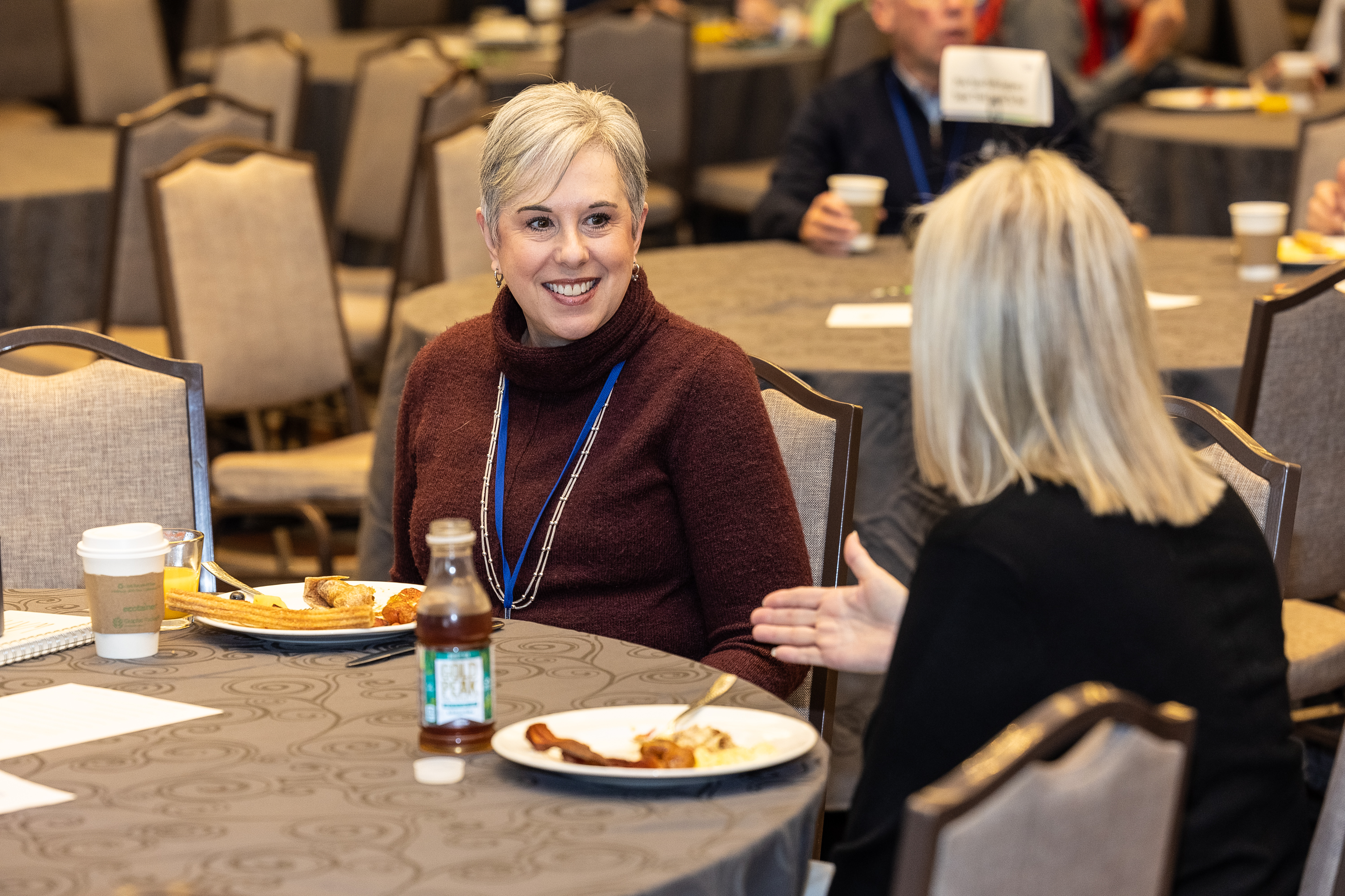 Attendees in discussion over a meal at Directors Conference 2025