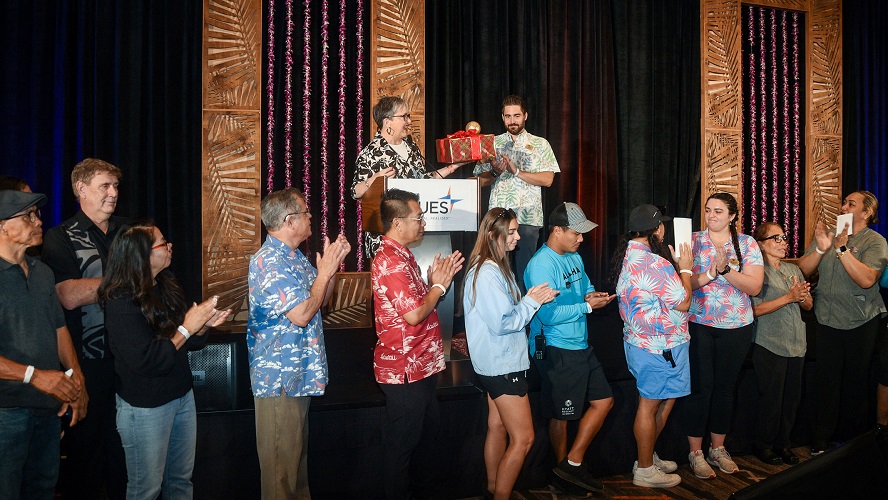 Luke Yurek, Hyatt Regency Maui Director of Rooms, and hotel staff affected by the Maui wildfires join CUES CEO Heather McKissick during CUES Directors Conference 2023 to receive donations given through The Gift Card Drive. 